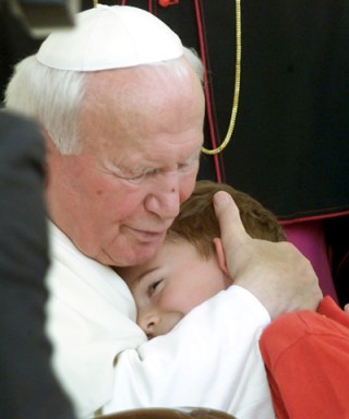 POPE EMBRACES CHILD DURING AUDIENCE